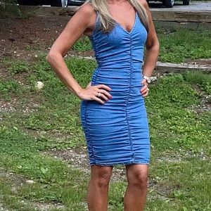 A ruched zip up denim dress